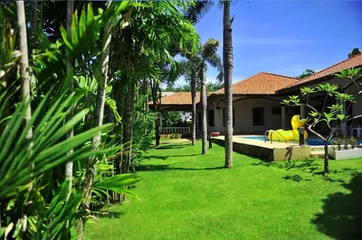 a backyard with a pool with a yellow inflatable at Kesorn Charming Authentic Thai Pool Villa Phuket in Rawai Beach