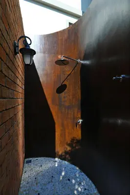 a bathroom with a shower in a brick wall at Mountain View Apart Naiyang Beach in Phuket