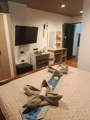 a bedroom with a bed with two towels on it at Hop guest House in Patong Beach