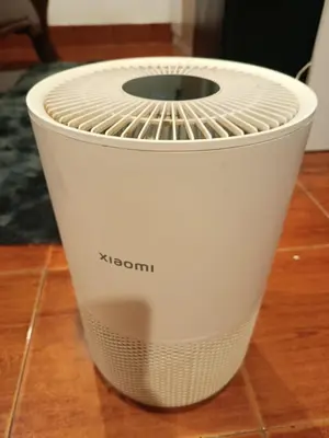 a white fan sitting on top of a wooden floor at Hop guest House in Patong Beach