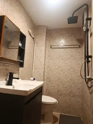a bathroom with a sink and a toilet and a shower at Hop guest House in Patong Beach