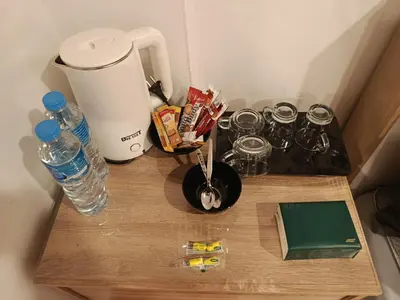 a table with a blender and a bottle of water at Hop guest House in Patong Beach