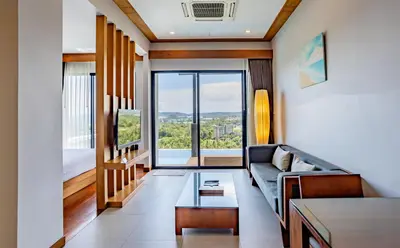 a living room with a couch and a large window at Sea & Mountain View Private Pool Villa at Aonang Beach in Krabi town