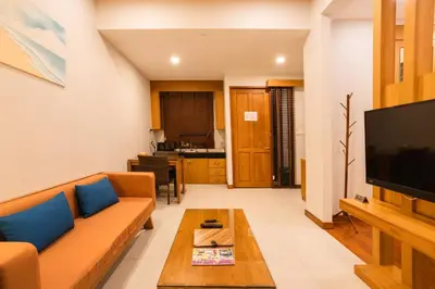 a living room with a couch and a tv at Sea & Mountain View Private Pool Villa at Aonang Beach in Krabi town