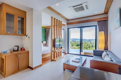 a living room with a couch and a bedroom at Sea & Mountain View Private Pool Villa at Aonang Beach in Krabi town