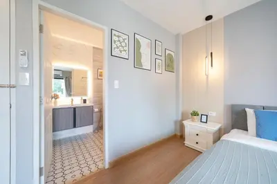 a bedroom with a king sized bed and a bathroom at New Charming Patong Pool villa 5 mins walk Bangla beach in Patong Beach