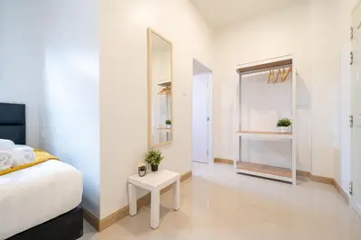 a bedroom with a bed and a mirror and a table at New Charming Patong Pool villa 5 mins walk Bangla beach in Patong Beach