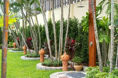 a row of fire hydrants in a garden at Villa Conhei in Rawai Beach