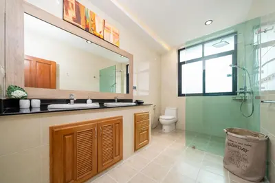 a bathroom with a sink and a shower and a toilet at Villa Conhei in Rawai Beach