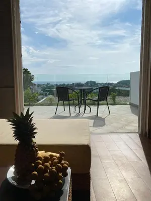 a plate of fruit on a table in front of a window at Kata Ocean View 1 bedroom Sea View 71 m2 in Kata Beach