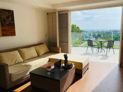 a living room with a couch and a table at Kata Ocean View 1 bedroom Sea View 71 m2 in Kata Beach