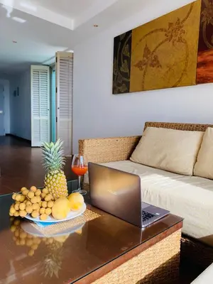 a living room with a laptop on a coffee table at Kata Ocean View 1 bedroom Sea View 71 m2 in Kata Beach