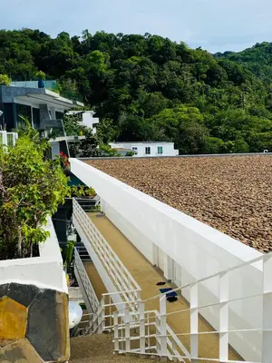 a white building with stairs on the side of it at Kata Ocean View 1 bedroom Sea View 71 m2 in Kata Beach