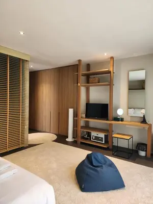 a bedroom with a bed and a tv and a room at Luxury Beachfront BRAHMA Villa 4 Br at Ta-Ke Residence B in Phuket