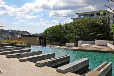 a swimming pool with steps in the water at Spacious studio near Karon beach by Pro ARK-204 in Phuket Town