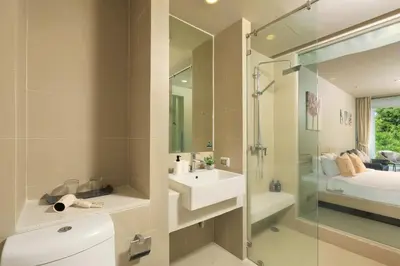 a bathroom with a sink and a glass shower at Spacious studio near Karon beach by Pro ARK-204 in Phuket Town