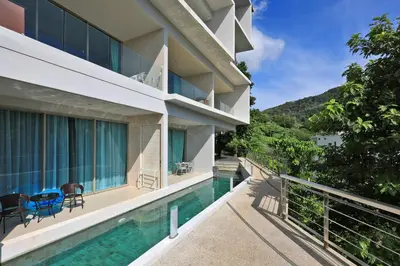 a balcony of a building with a swimming pool at Spacious studio near Karon beach by Pro ARK-204 in Phuket Town