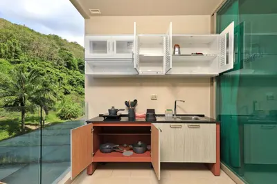 a kitchen with a counter with a sink and a window at Spacious studio near Karon beach by Pro ARK-204 in Phuket Town