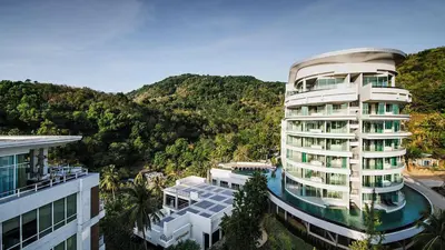 a large building with a river in front of a mountain at Spacious studio near Karon beach by Pro ARK-204 in Phuket Town