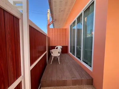 a small balcony with a chair on a house at 2 Bedroom Pool Villa in Ban Na Bon