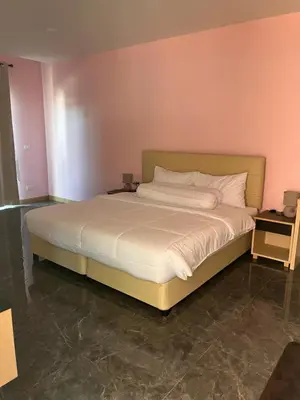 a bedroom with a large bed with white sheets at 2 Bedroom Pool Villa in Ban Na Bon