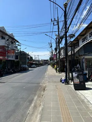 an empty street in a town with shops at Mildmint มายมิ้นท์อพาร์ทเม้นท์ Self Serviced in Kata Beach