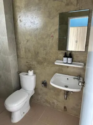 a bathroom with a toilet and a sink and a mirror at Mildmint มายมิ้นท์อพาร์ทเม้นท์ Self Serviced in Kata Beach