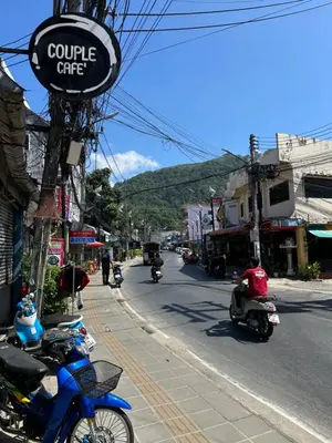 a group of people riding motorcycles down a street at Mildmint มายมิ้นท์อพาร์ทเม้นท์ Self Serviced in Kata Beach