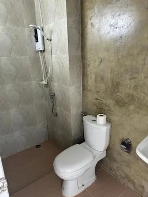 a bathroom with a white toilet and a sink at Mildmint มายมิ้นท์อพาร์ทเม้นท์ Self Serviced in Kata Beach