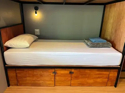 a bed in a room with a large mattress at Hangover Chill & Hill Hostel in Phi Phi Don