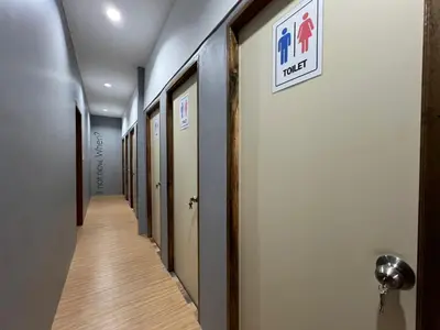 a hallway of a hospital with a sign on the wall at Hangover Chill & Hill Hostel in Phi Phi Don