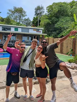 a group of people posing in front of a pool at Hangover Chill & Hill Hostel in Phi Phi Don