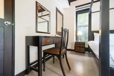 a bedroom with a desk and a bed and a mirror at Luxurious Villa Near Bangtao Beach in Bang Tao Beach