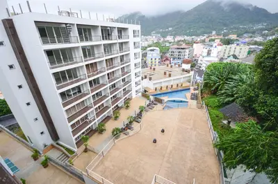 an aerial view of a large building with a pool at Large, quiet Condo by รินดา Rinrada in Patong Beach