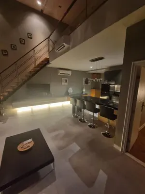a living room with a kitchen and a staircase at Penthouse Seaview poolview 140sqm panoramic B43 in Kamala Beach