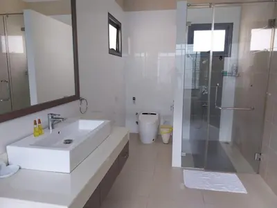 a white bathroom with a sink and a shower at Villa Destiny AZ in Ban Saiyuan (1)