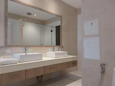 a bathroom with two sinks and a large mirror at Villa Destiny AZ in Ban Saiyuan (1)