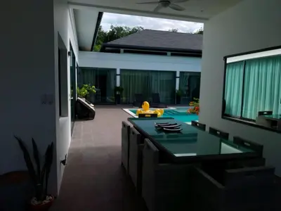 a kitchen with a table in a house at Villa Destiny AZ in Ban Saiyuan (1)