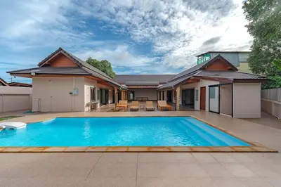 a swimming pool in front of a house at V155 4BR Large Family Villa Chalong in Chalong
