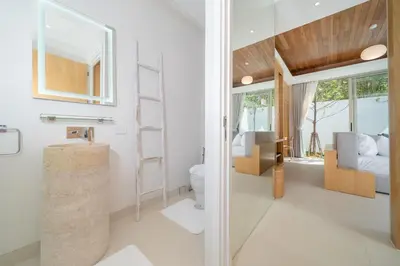 a bathroom with a sink and a toilet and a bedroom at Elite Living - Design 3BR Pool Villa in Newly Built LuxPride 4 L6 Residence in Bang Tao Beach