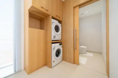 a laundry room with a washer and a washing machine at Elite Living - Design 3BR Pool Villa in Newly Built LuxPride 4 L6 Residence in Bang Tao Beach