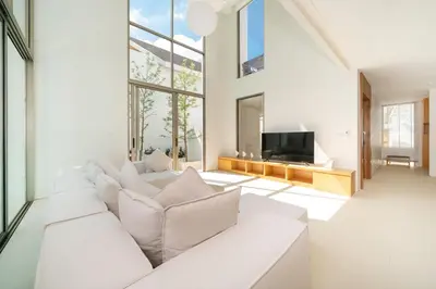 a living room with a white couch and a tv at Exclusive New Build - Designer 3BR Pool Villa in Prestigious LuxPride 4 L7 Residence in Bang Tao Beach