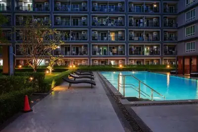 a large building with a swimming pool in front of it at Luxury Residence in Phuket Center in Phuket Town