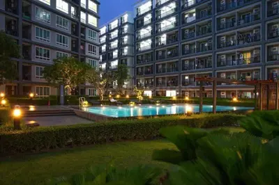 a large apartment building with a swimming pool at night at Luxury Residence in Phuket Center in Phuket Town