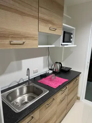 a kitchen with a sink and a pink towel at Luxury Residence in Phuket Center in Phuket Town