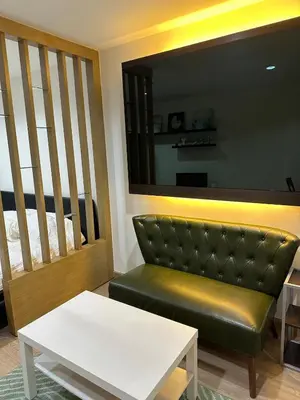 a living room with a couch and a table at Luxury Residence in Phuket Center in Phuket Town