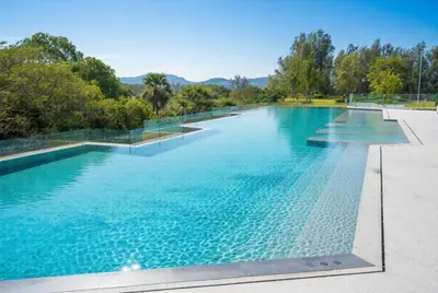 a large swimming pool with blue water at Laguna Beachside residences apartamens, walking distance to the sea in Bang Tao Beach