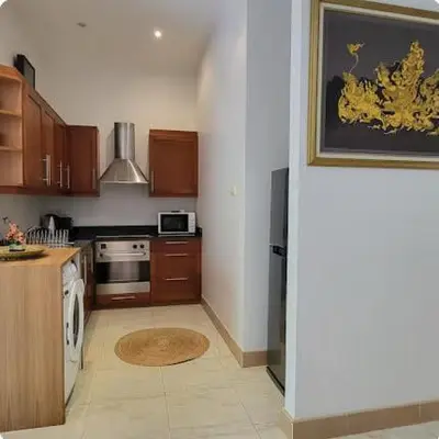 a kitchen with a sink and a stove top oven at Heavenly place in Surin Beach