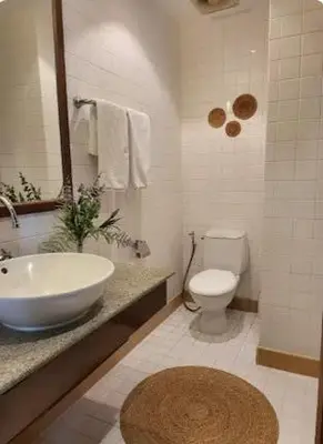 a white bathroom with a sink and a toilet at Heavenly place in Surin Beach