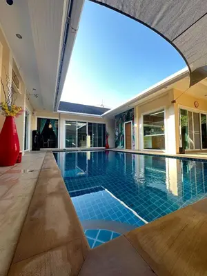 a swimming pool in a house with a large window at 4Bedroom Villa with Private Pool in Ban Klang